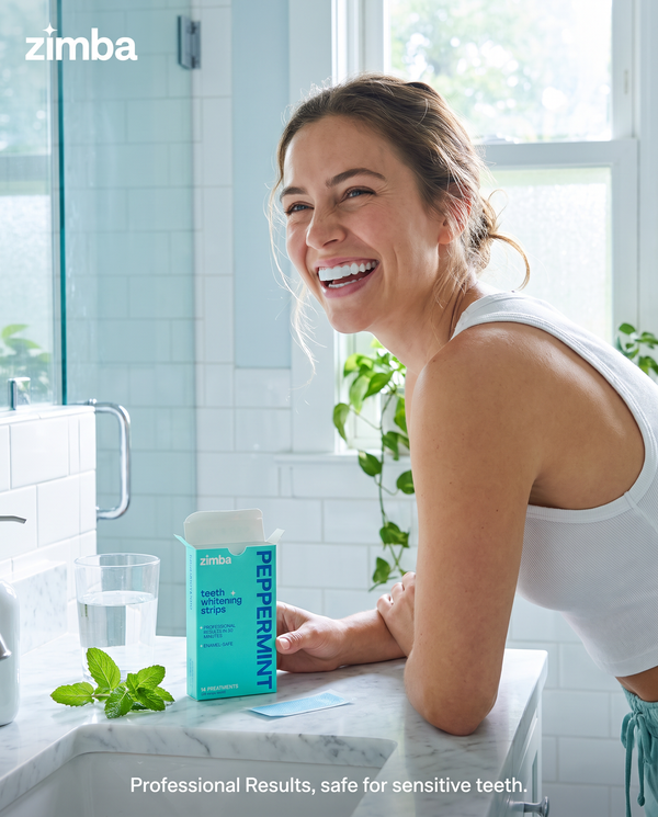 Zimba Teeth Whitening Strips Peppermint Woman smiling in bathroom box #peppermint